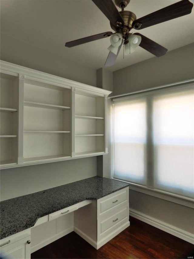 unfurnished office featuring ceiling fan and dark hardwood / wood-style flooring