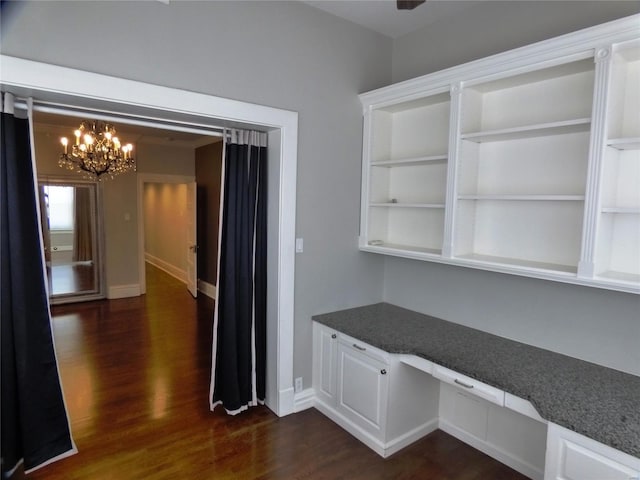 interior space featuring dark hardwood / wood-style floors and a chandelier