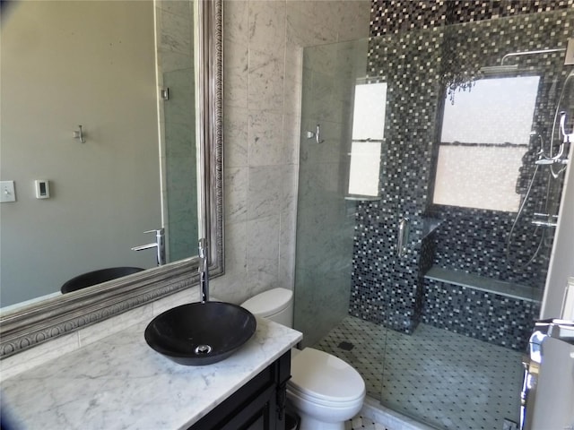 bathroom with walk in shower, toilet, and vanity