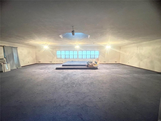 carpeted empty room with a textured ceiling