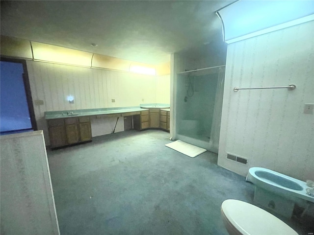 bathroom with a bidet, vanity, an enclosed shower, concrete floors, and toilet