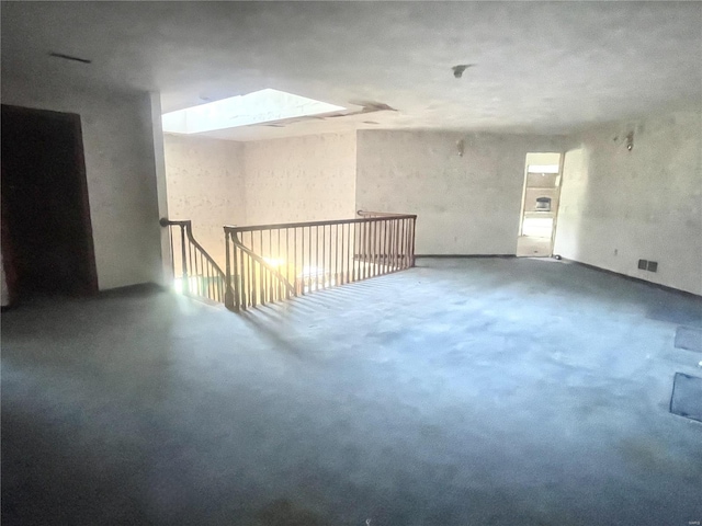 spare room featuring a skylight