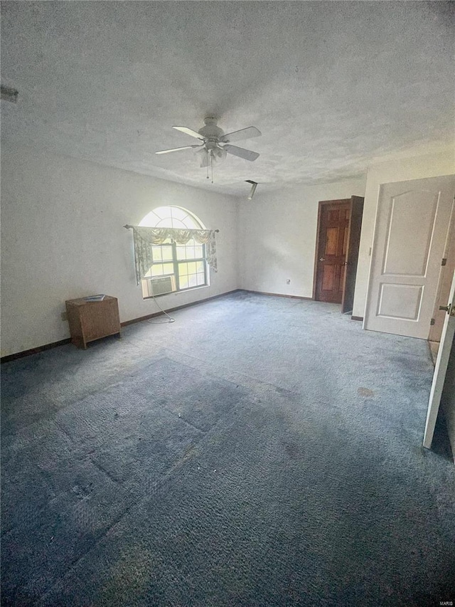 interior space featuring a textured ceiling, ceiling fan, and carpet floors