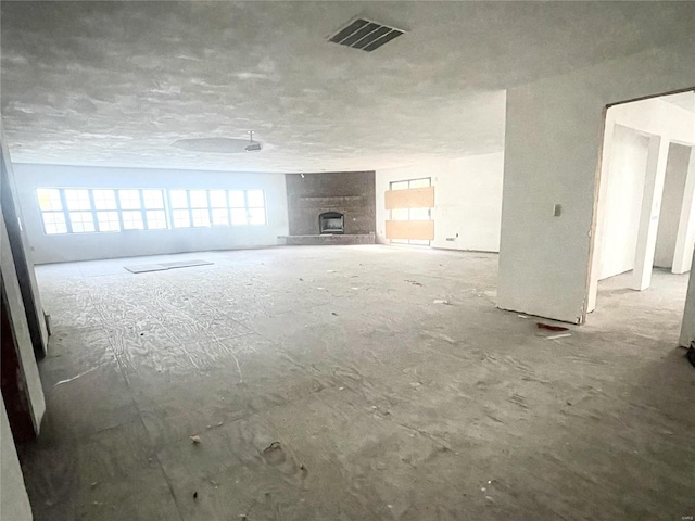 unfurnished living room featuring a large fireplace