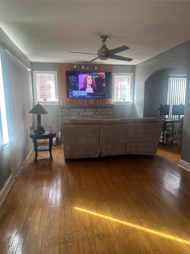 unfurnished living room featuring hardwood / wood-style floors and ceiling fan