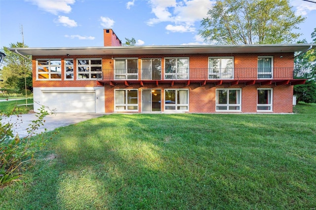 exterior space featuring a balcony, a yard, and a garage