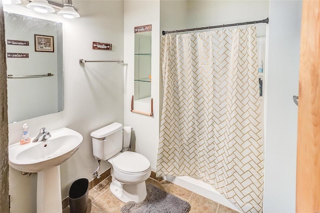 bathroom with toilet, walk in shower, and tile patterned floors