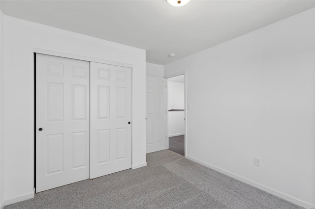 unfurnished bedroom with a closet and carpet