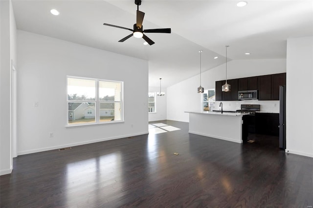 kitchen featuring a kitchen island with sink, stainless steel appliances, ceiling fan, dark wood-type flooring, and lofted ceiling