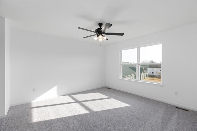 unfurnished room with ceiling fan and carpet flooring