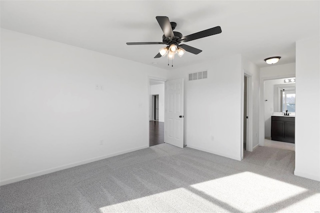 carpeted spare room with ceiling fan