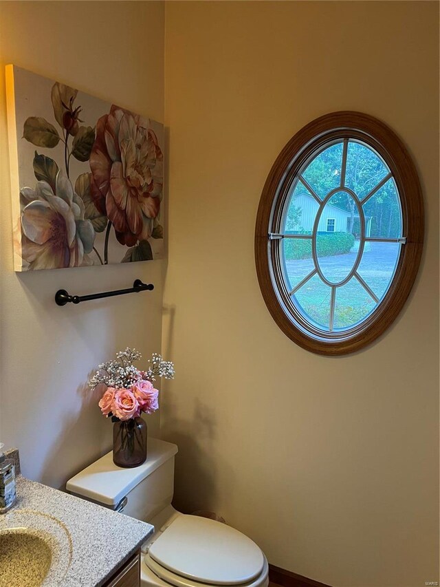 bathroom featuring vanity and toilet