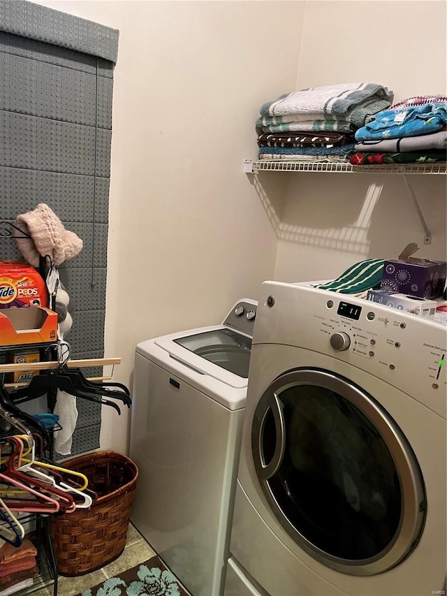 laundry room featuring tile patterned flooring and washing machine and dryer