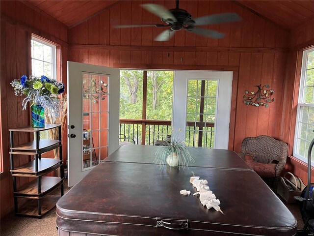 dining area featuring wood walls, wooden ceiling, vaulted ceiling, and a wealth of natural light