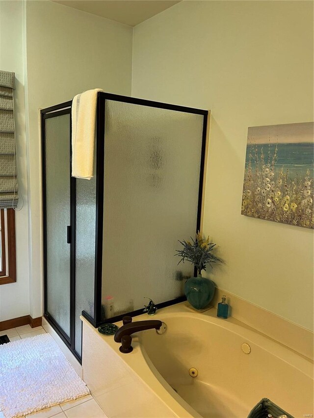 bathroom with shower with separate bathtub and tile patterned floors