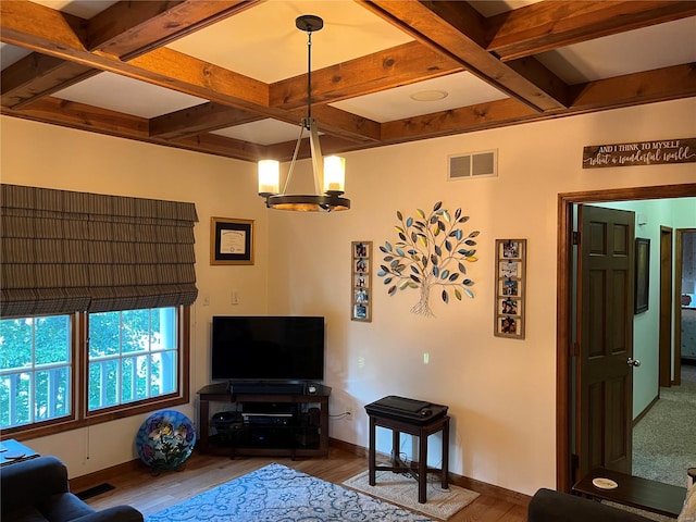 living room featuring an inviting chandelier, beamed ceiling, coffered ceiling, and hardwood / wood-style flooring