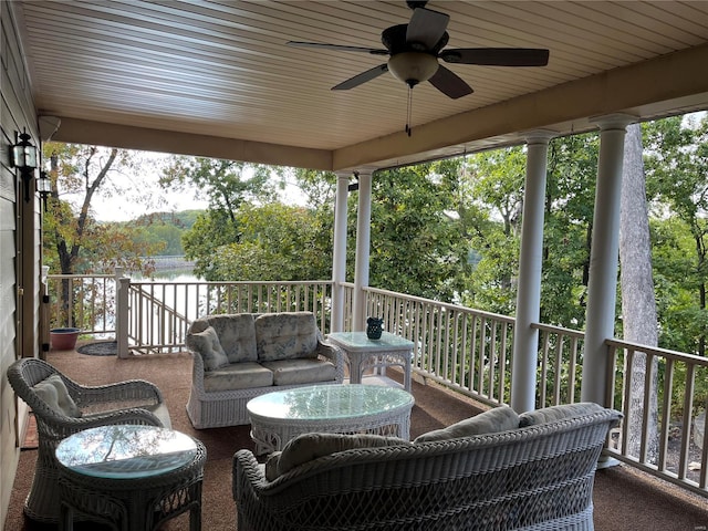 wooden deck with an outdoor living space and ceiling fan