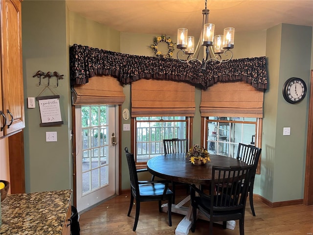 dining area featuring a notable chandelier and hardwood / wood-style floors