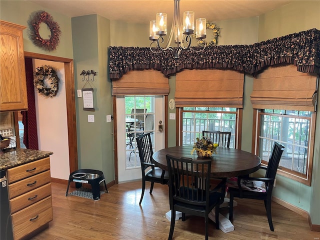 dining room with a chandelier, light hardwood / wood-style floors, and a wealth of natural light