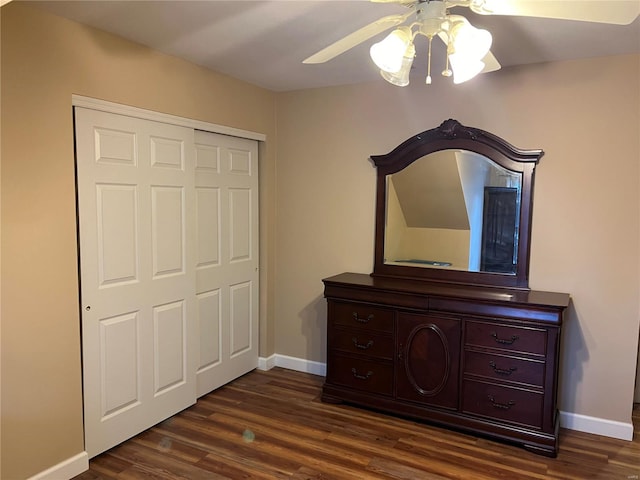 unfurnished bedroom with a closet, dark hardwood / wood-style floors, and ceiling fan