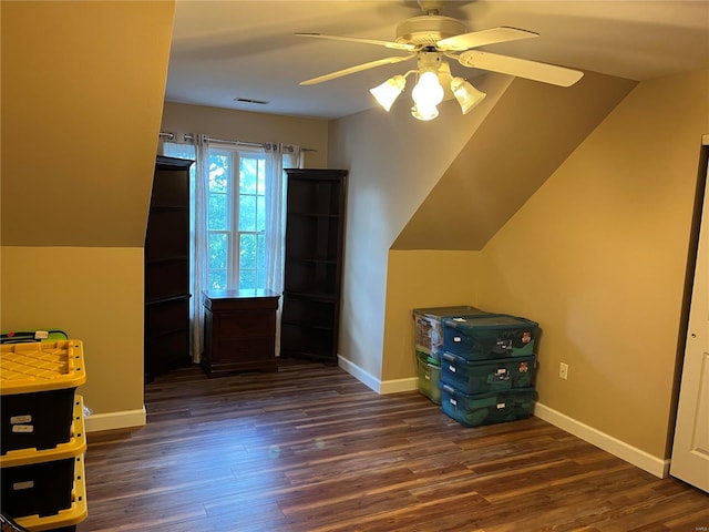 bonus room with ceiling fan and dark wood-type flooring