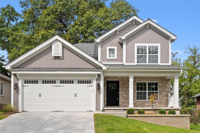 craftsman house with stone siding, board and batten siding, covered porch, concrete driveway, and a garage