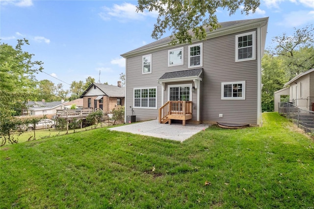 back of property featuring a patio area, a lawn, and fence