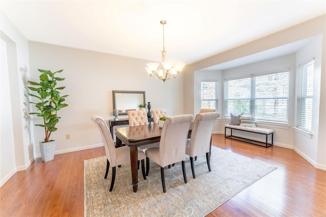 dining space featuring a chandelier and light wood-type flooring