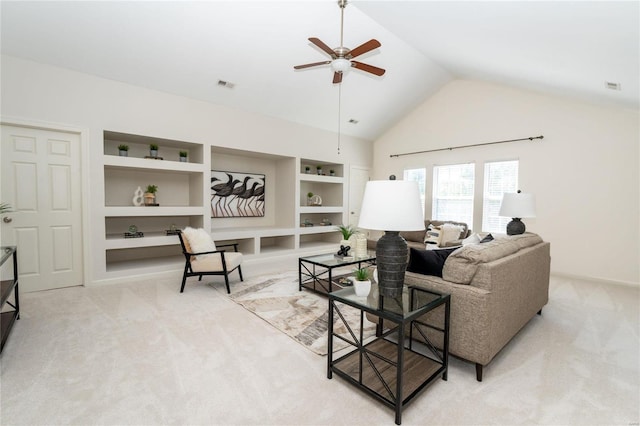 carpeted living room featuring ceiling fan, built in features, and vaulted ceiling