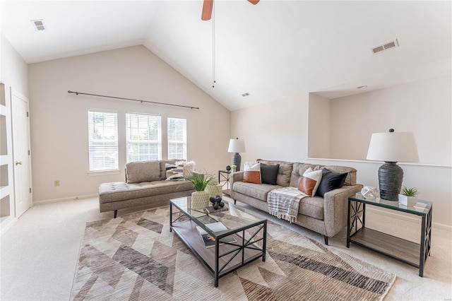 carpeted living room featuring ceiling fan and vaulted ceiling