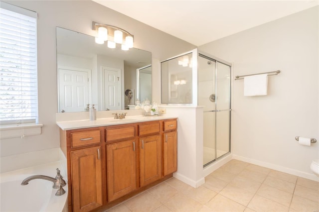 bathroom featuring tile patterned flooring, shower with separate bathtub, and vanity