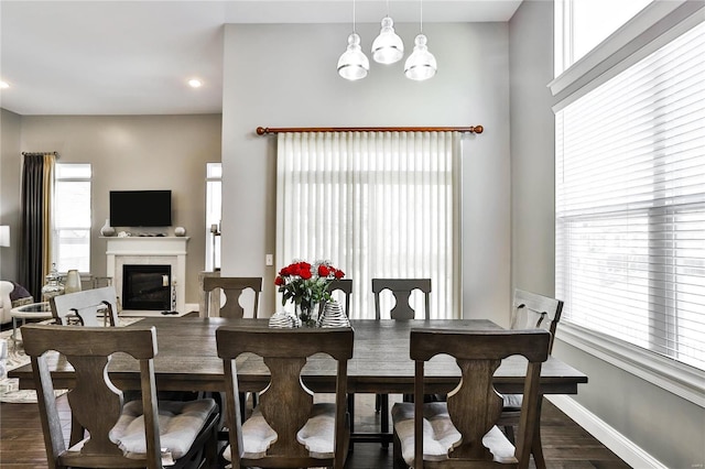 dining space with dark hardwood / wood-style flooring and a notable chandelier