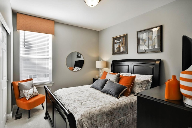 bedroom featuring carpet, multiple windows, and a closet