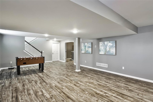 basement with hardwood / wood-style floors