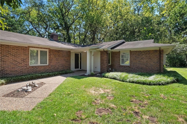 ranch-style home featuring a front yard