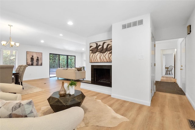 living room with hardwood / wood-style flooring and a chandelier