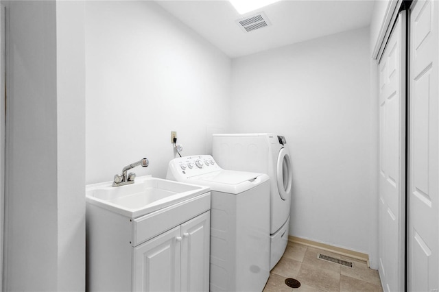 washroom featuring cabinets and washer and dryer