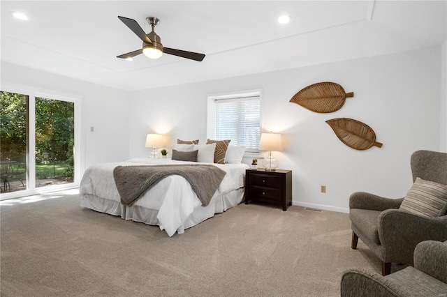 carpeted bedroom featuring ceiling fan and multiple windows