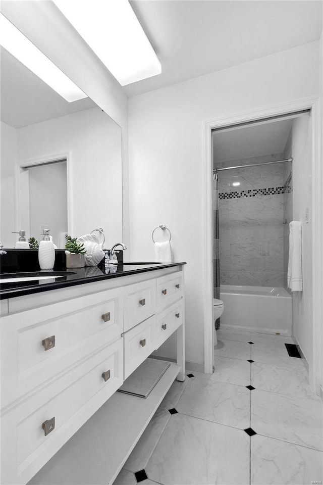 full bathroom featuring toilet, tiled shower / bath combo, and vanity