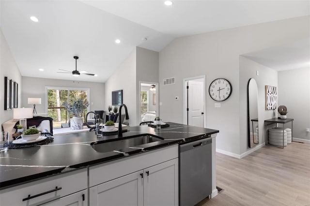 kitchen with visible vents, a ceiling fan, lofted ceiling, dark countertops, and stainless steel dishwasher