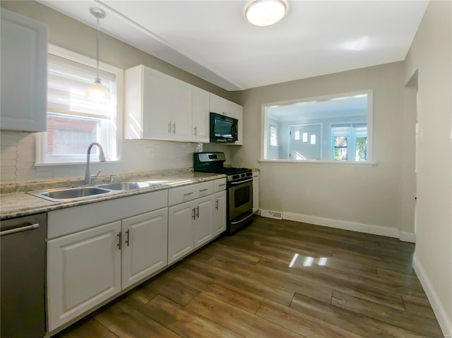 kitchen with stainless steel appliances, dark hardwood / wood-style floors, and white cabinetry