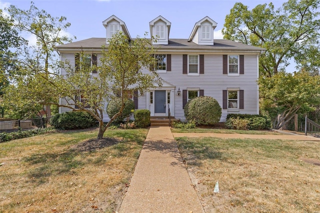 colonial-style house with a front lawn