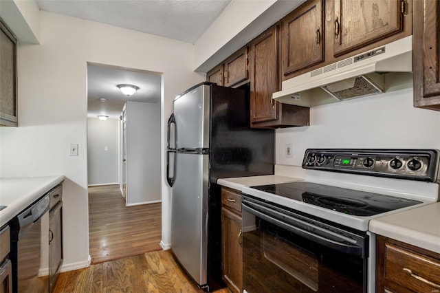 kitchen with hardwood / wood-style flooring, stainless steel dishwasher, electric range, and dark brown cabinetry