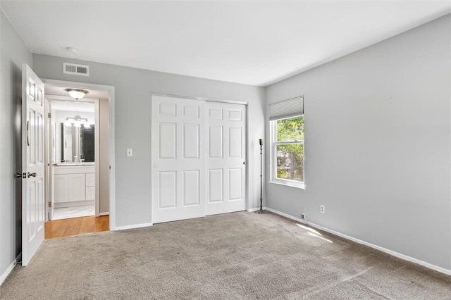 unfurnished bedroom featuring a closet and carpet floors