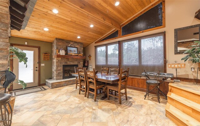 dining room featuring wood ceiling, vaulted ceiling with beams, and a fireplace