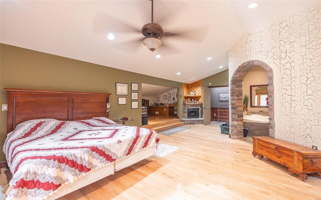 bedroom featuring light wood-type flooring, vaulted ceiling, and ceiling fan