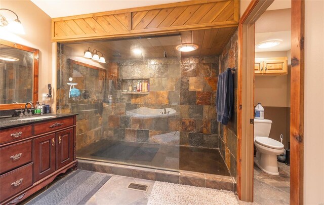 bathroom featuring vanity, toilet, and a tile shower