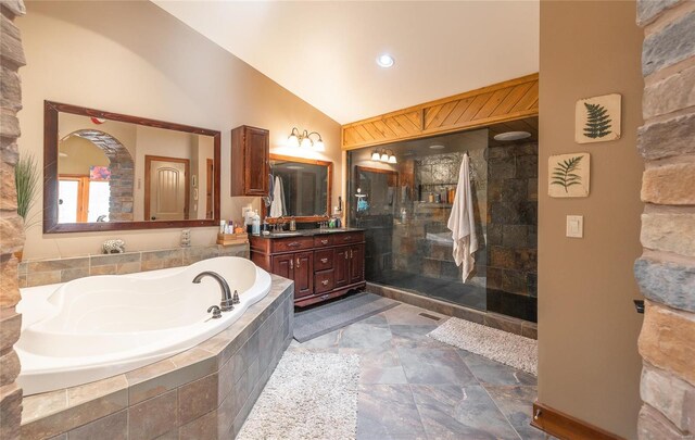 bathroom with vanity, lofted ceiling, and separate shower and tub