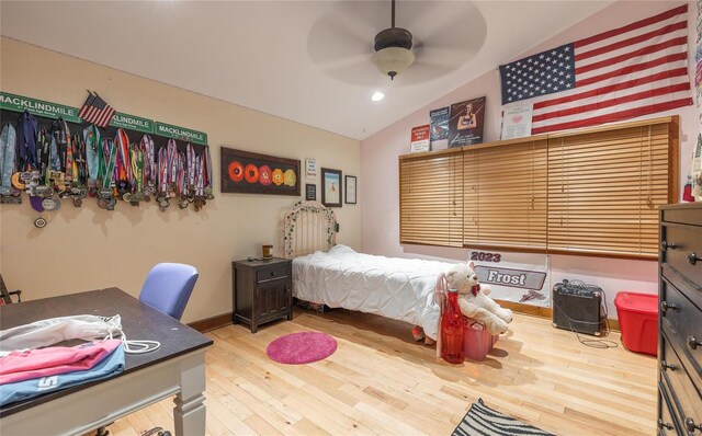 bedroom with lofted ceiling, ceiling fan, and light wood-type flooring