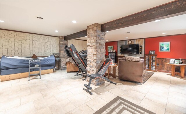 workout room featuring ornamental molding and ornate columns